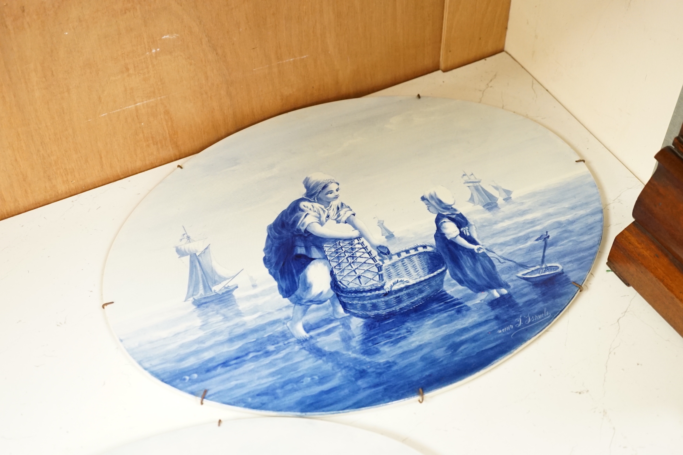 Three late 19th/early 20th century Delft oval landscape plaques, 45cm